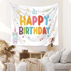 Detailed close-up of a colorful Happy Birthday tapestry on a minimalist white bedroom wall