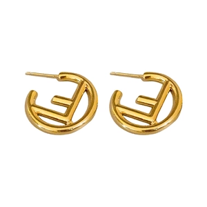 Minimalist gold metal C-shaped stud earrings featuring an openwork F letter design