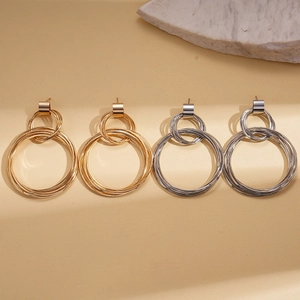 Modern gold and silver layered geometric round drop earrings with a metallic finish