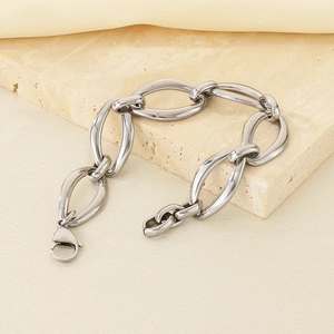 Macro view of polished silver stainless steel link chain with secure lobster clasp on stone