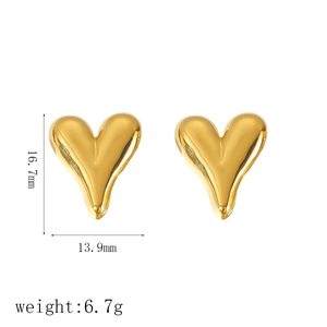 Polished 18k gold heart earrings set in titanium steel on a white background