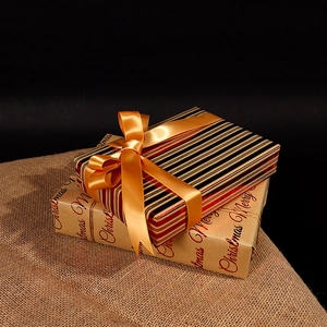 Christmas gift wrapping paper set with festive gold foil patterns and satin ribbons