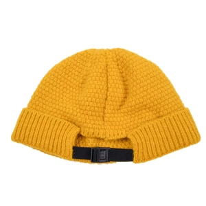 Detail of waffle knit texture and adjustable black strap buckle on yellow beanie
