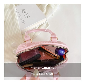 Internal capacity of pink PVC shell bag showing lipstick and cosmetic storage