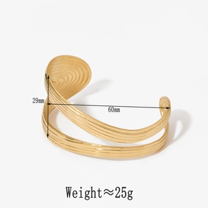 Detailed view of gold wide open bangle featuring twisted spiral texture and dimension specs