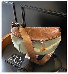 Detail of mixed-material crossbody bag showing green nylon and textured brown PU leather