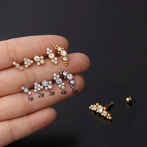 Detailed macro view of 16g stainless steel cartilage earrings with zircon screw back studs