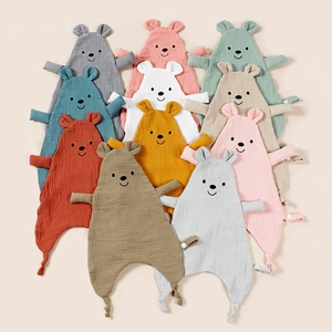 Flat lay of multiple colorful muslin cotton baby comforters with cute bear design