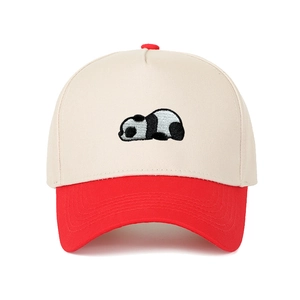 Close-up of a panda embroidery on a two-tone trucker hat with cream canvas and red brim