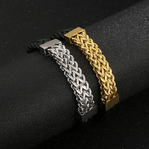 Detail of black braided leather bracelets with gold and silver magnetic steel clasps