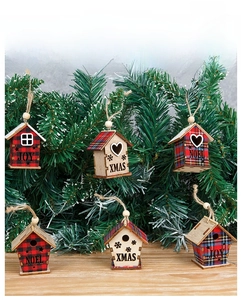 Detailed view of wooden Christmas house ornaments with plaid patterns and festive carvings