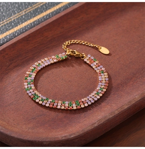 Detailed view of gold plated titanium bracelet with colorful square zircon stones