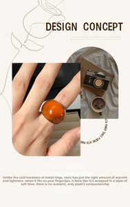 Artistic layout showing amber resin dome ring with vintage camera and lifestyle props