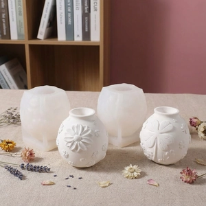 Macro shot of 3D daisy and clover embossed spherical silicone molds for DIY candle holders