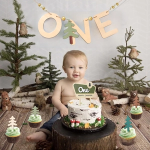Wooden ONE banner and pine tree cake toppers for first birthday camping theme