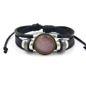 Detail of multi-layer black leather bracelet with purple stone and bronze metal beads