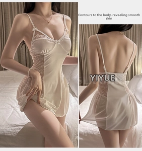 Detail view of white lace patchwork lingerie sleepwear with delicate bow and silk texture