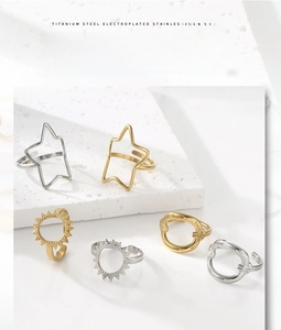 Close-up of gold and silver plated stainless steel rings with hollow star and sun motifs
