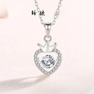 Macro view of S925 silver crown heart necklace with dancing stone detail