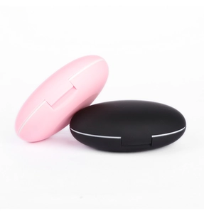 Compact travel makeup brush set case in matte pink and black with mirror design