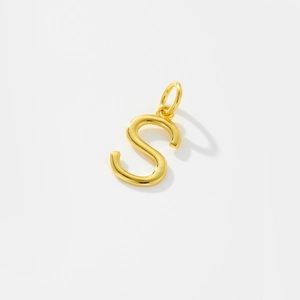 Polished gold S-shaped pendant detail showing high-gloss finish and sleek metal texture