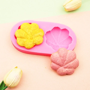 Detailed macro view of pink silicone flower mold with finished yellow and pink crafts