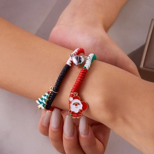 Close-up of magnetic heart clasp on braided Christmas Santa and tree bracelets