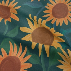 Detailed macro view of vibrant sunflower pattern on soft forest green woven tapestry fabric