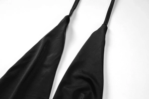 Détail du décolleté en V et des coutures sur la robe moulante noire sans manches