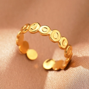 Detail of bohemian gold adjustable ring featuring a unique geometric concave circle design