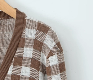 Close-up of brown and white checkered knit cardigan showing neckline and shoulder seams