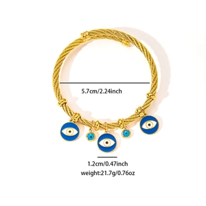 Detailed size view of woven gold steel bracelet with blue evil eye enamel charms