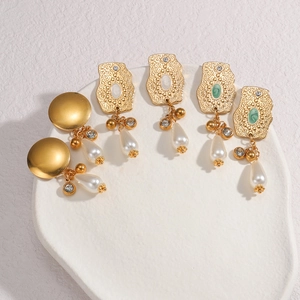 Luxury gold pearl earrings set with irregular geometric designs and green zircon details