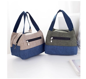 Detail view of canvas lunch bags with dual-tone design and sturdy webbing handles