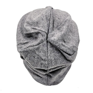 Detail shot of dark gray knitted beanie showing fine textured fabric and top stitching