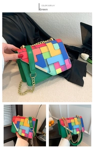 Detail of color-block crossbody bag featuring geometric patterns and golden metal chain
