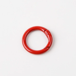 Detail view of a 23mm red lacquered metal spring ring buckle for keychains and bags