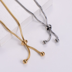 Adjustable snake chain bracelet in 18k gold and silver with spherical charms