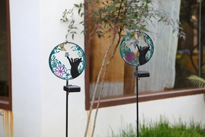 Detailed close-up of solar garden silhouette light featuring a black cat and butterfly design