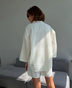 Rear view of white waffle knit loungewear set featuring long sleeve shirt and shorts
