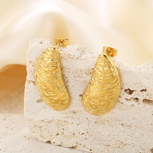 Detailed view of irregular gold stainless steel studs with textured finish on rock