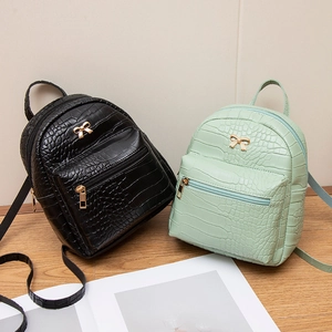 Mini crocodile pattern backpacks in black and mint green with golden bow hardware