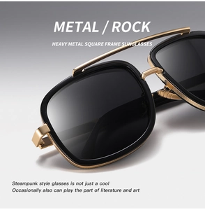 Close-up of steampunk square oversized sunglasses with black lenses and gold metal frame