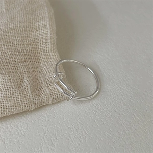 Minimalist 925 sterling silver adjustable ring with unique geometric bridge design on linen