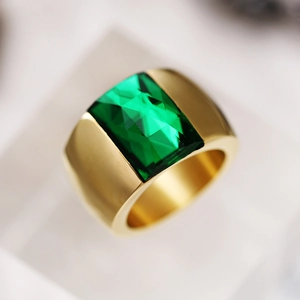 Elegant gold wide band ring featuring a large rectangular emerald green gemstone