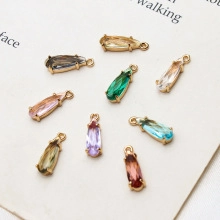 Macro shot of colorful teardrop zircon charms with gold plated alloy base for DIY jewelry