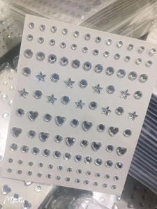 Detailed view of self-adhesive rhinestone stickers in heart, star, and round shapes