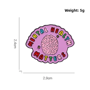 Detail view of pink brain enamel pin with Mental Health Matters text and dimensions