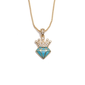 Gold plated crown necklace with zircon and blue gemstone pendant on a white background
