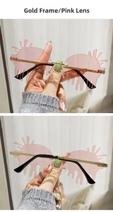 Detail view of pink teardrop rimless sunglasses with gold metal frame for party wear